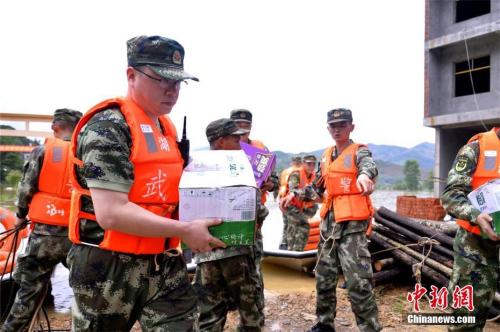 7月2日，武警黃石支隊(duì)官兵為湖北黃石市陽(yáng)新縣富河水庫(kù)下游的龍港鎮(zhèn)星潭村受災(zāi)民眾送去100件礦泉水和100箱方便面。 莊文偉 攝