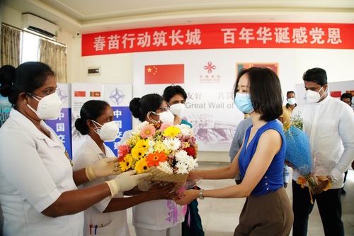 4月5日，在科倫坡港口城接種點，一名中國公民代表向當地醫護人員獻花致謝。新華社記者 唐璐 攝